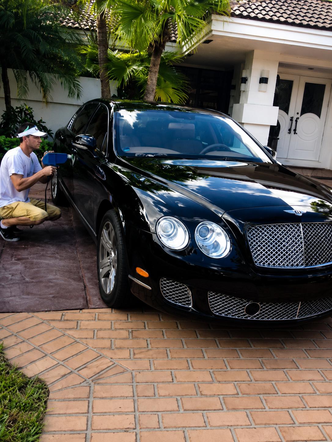 Technician performing computerized color matching on a Bentley